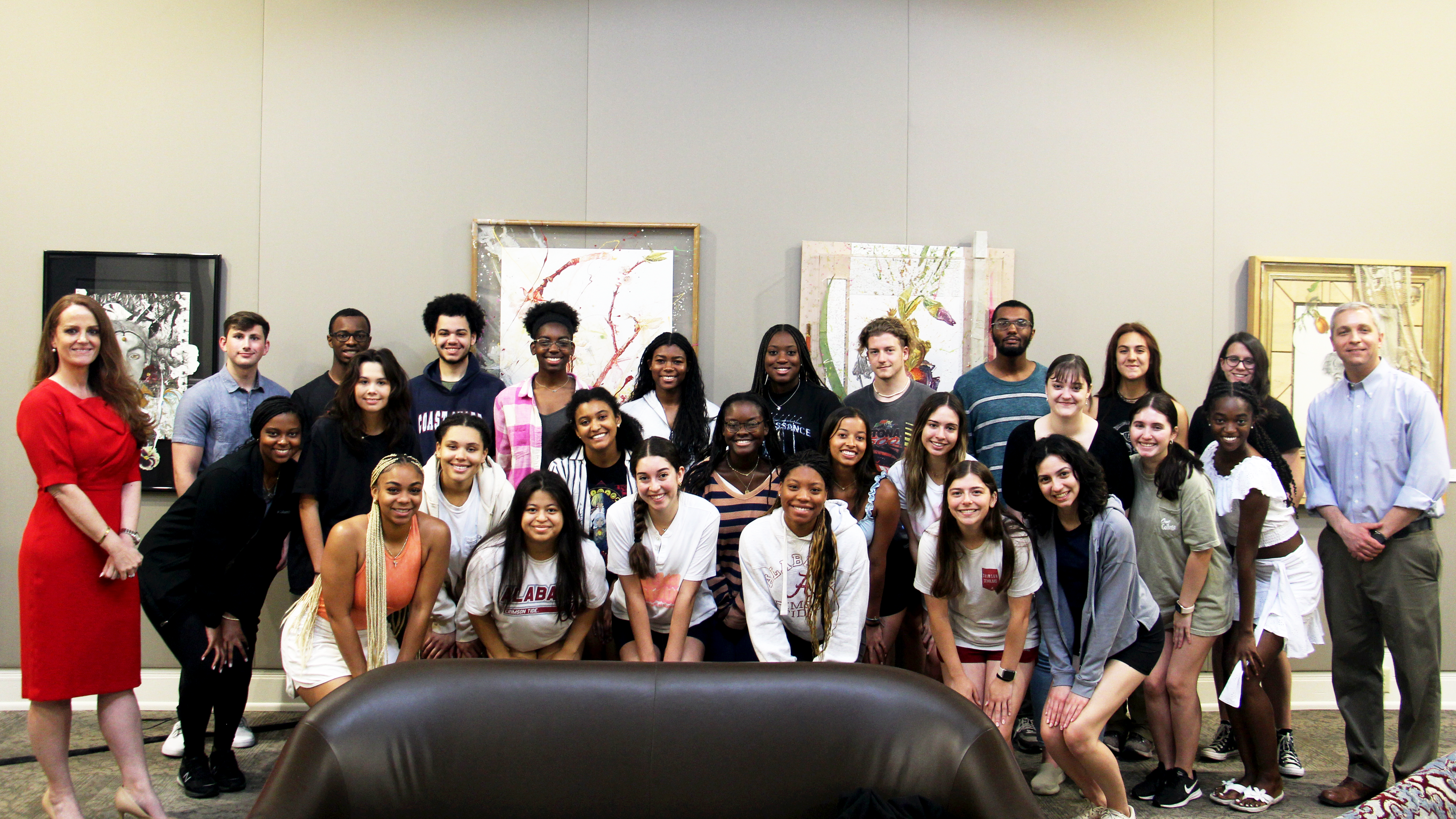 A group shot of the Achieve Scholars with Darren Surman and Dean Tiffany Sippial as they smile for the camera.