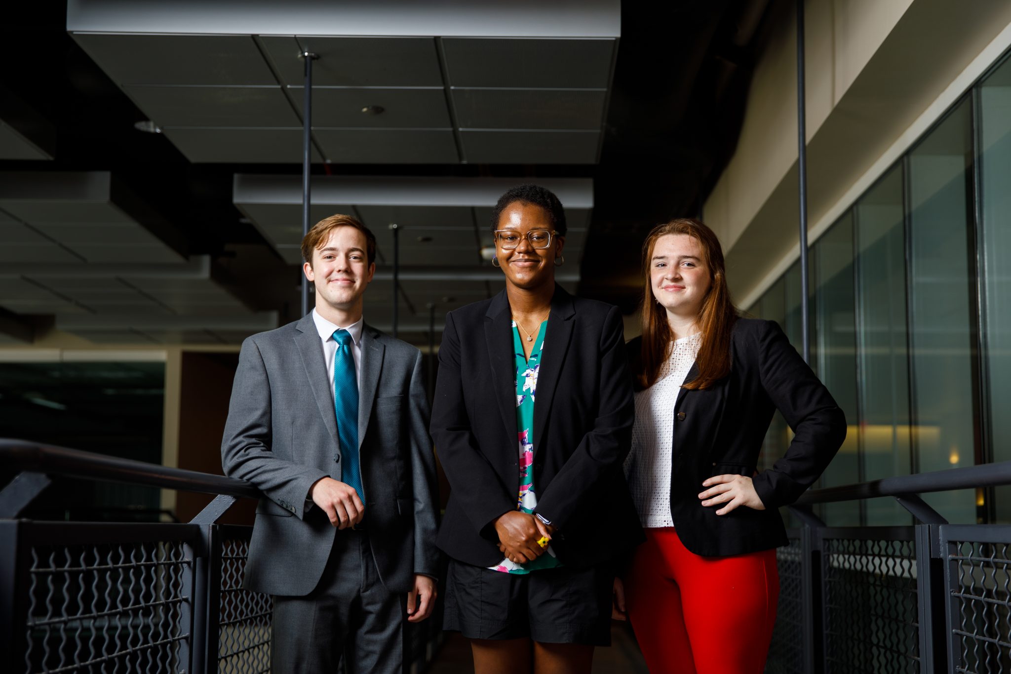 Three students smile for the camera.