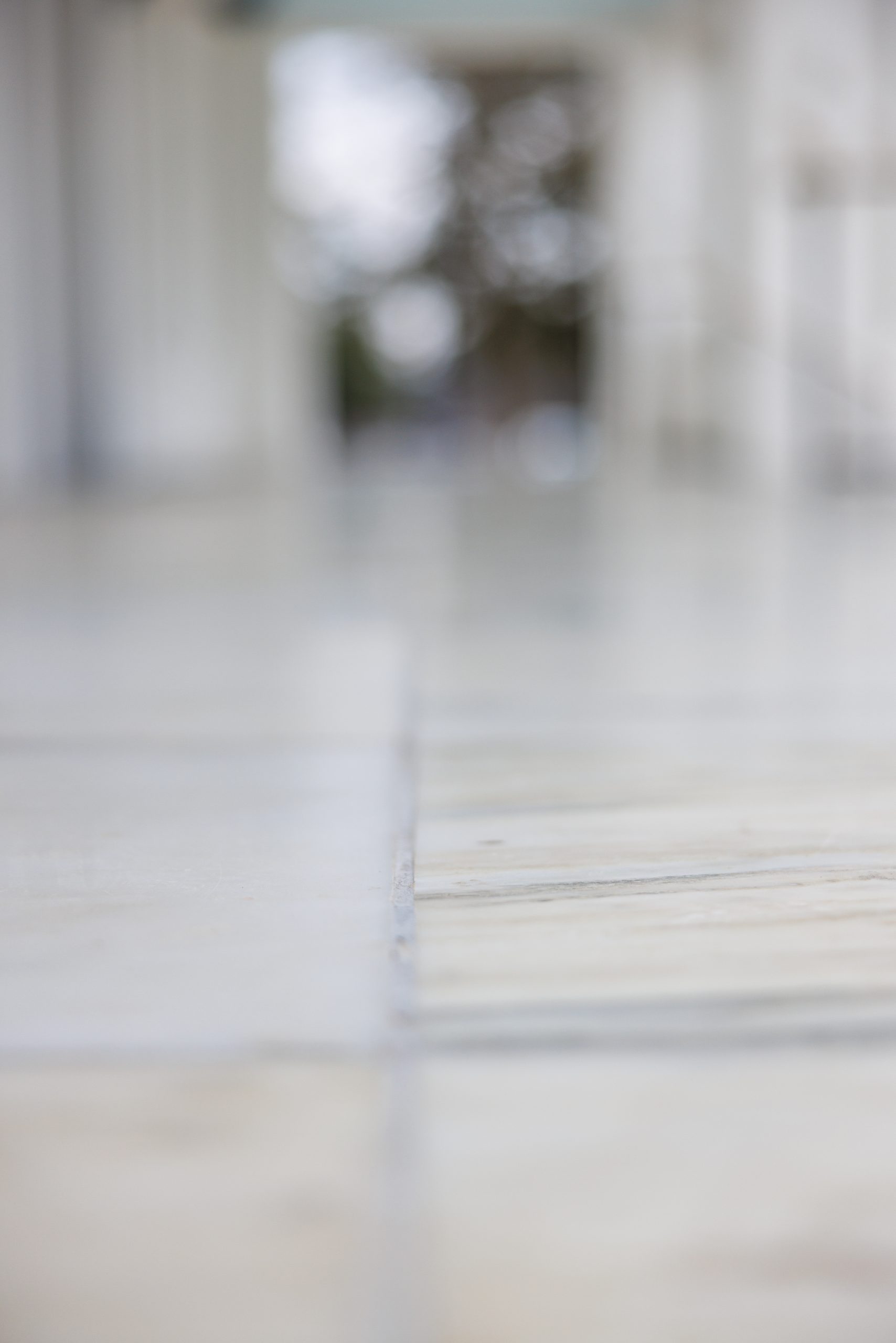 A photo of white tile floor.