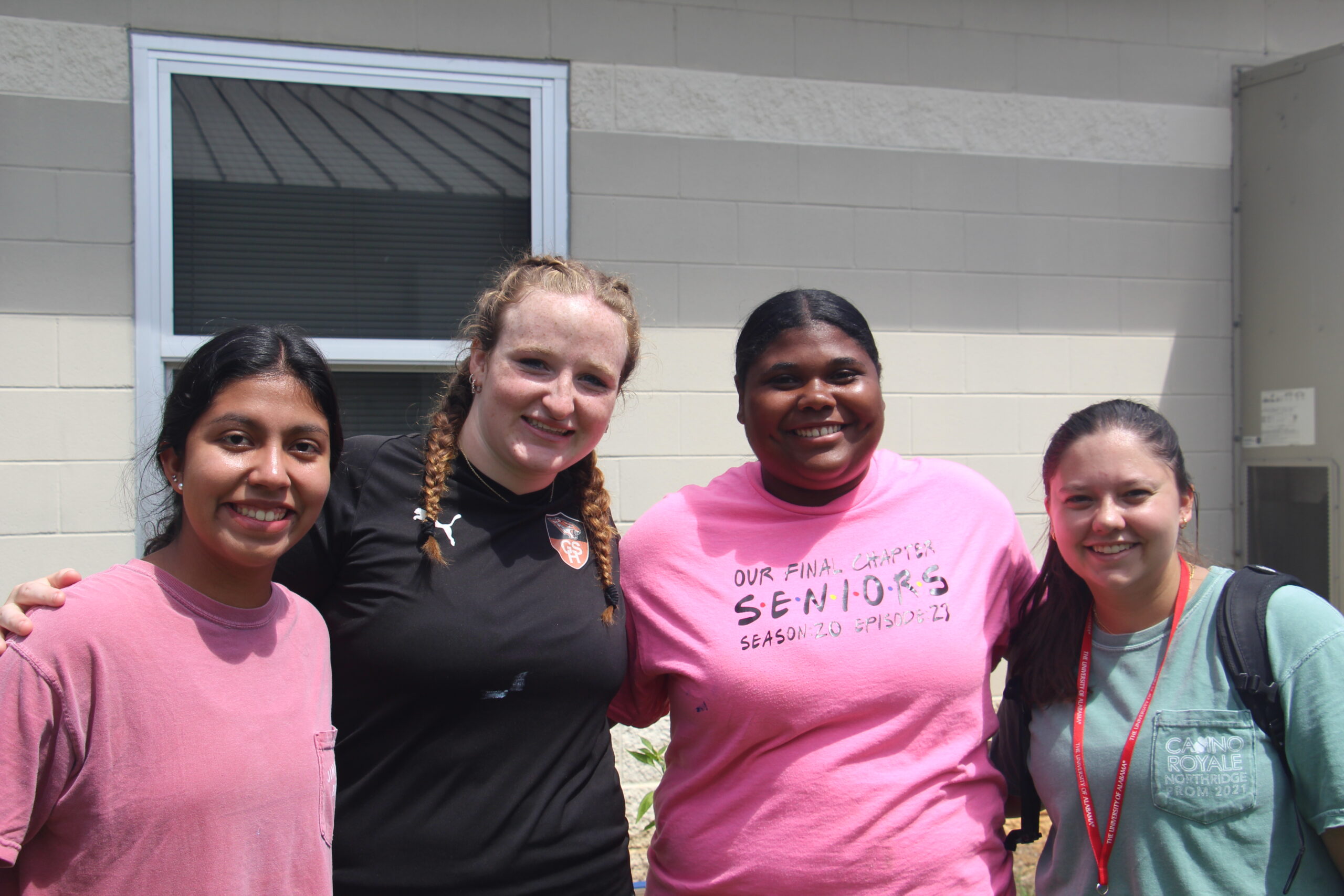 Four Honors Action students smile.