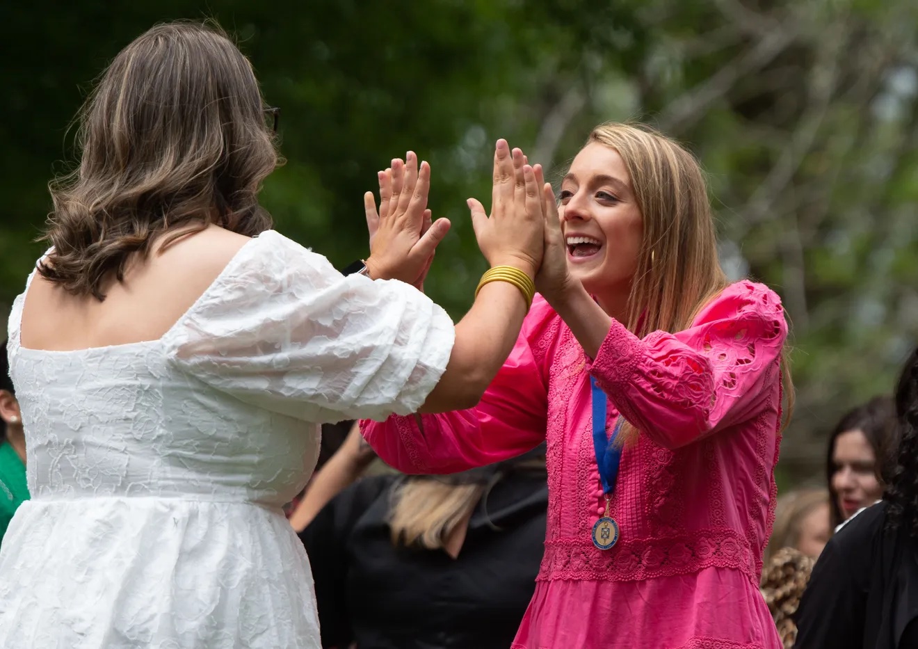 Two Witt Fellows giving each other a high five.