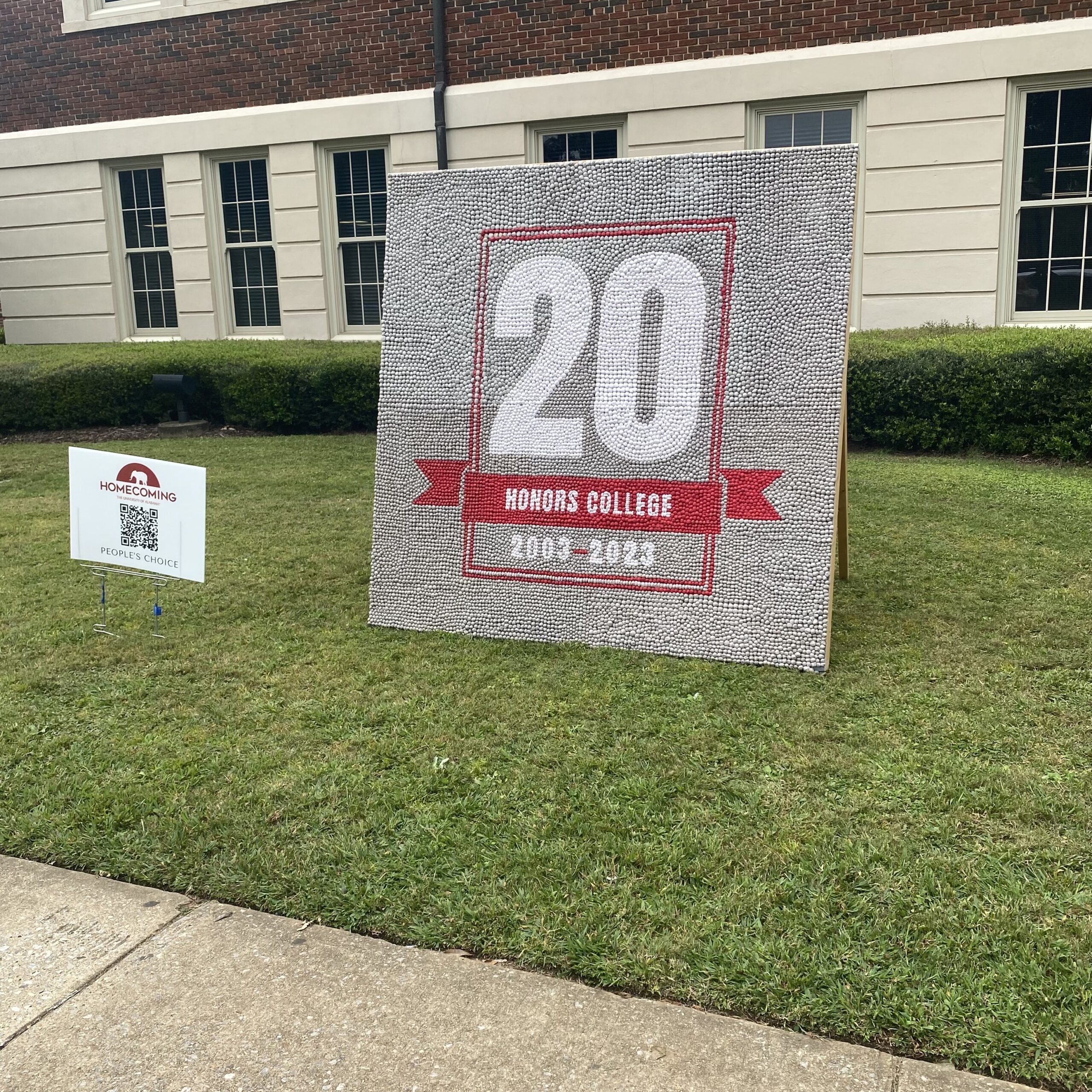 A pomping sign that reads, "20 Honors College 2003-2023."