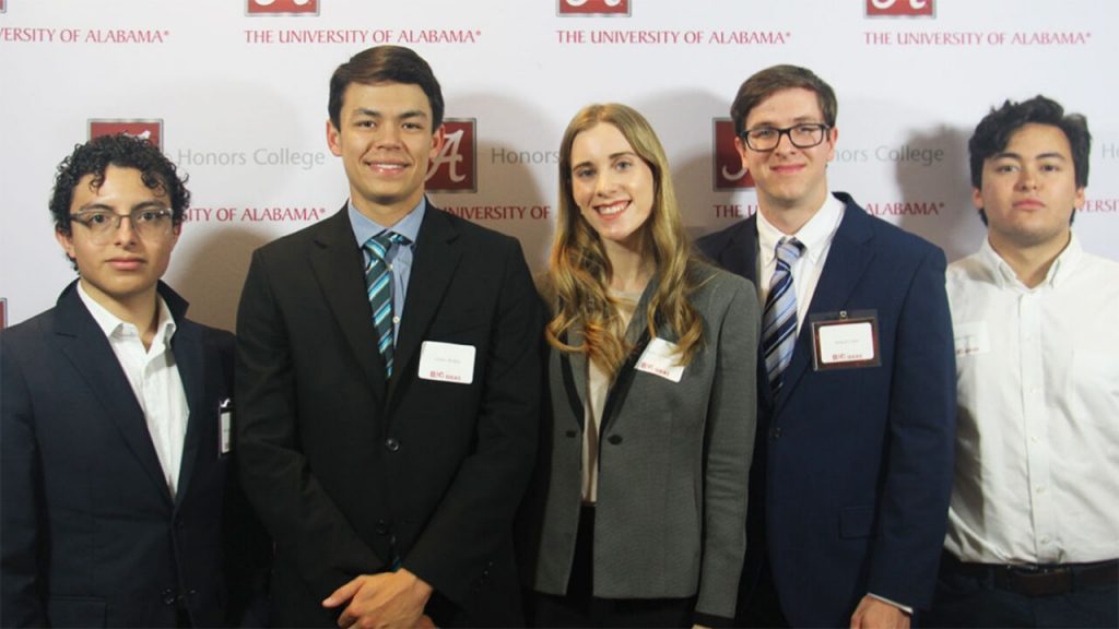 Five students of the StudyBuddy Team smile and pose for a photo.