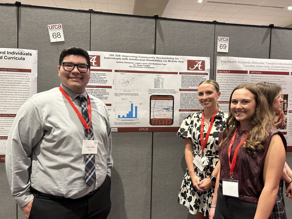Three Honors students pose with their research poster.